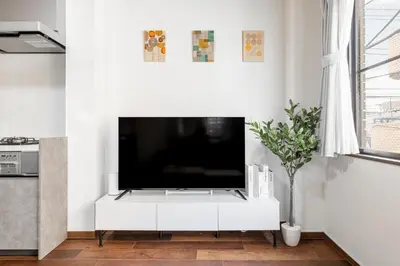 a living room with a tv on a white cabinet at -Numabukuro House- 10-minute walk from Numabukuro station in Tokyo