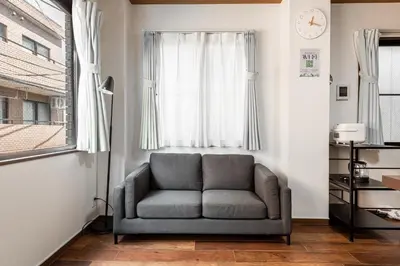 a grey chair in a room with a window at -Numabukuro House- 10-minute walk from Numabukuro station in Tokyo