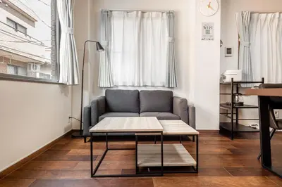 a living room with a couch and a table at -Numabukuro House- 10-minute walk from Numabukuro station in Tokyo
