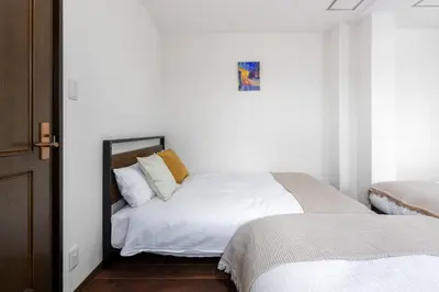 a bedroom with a white bed and a mirror at -Numabukuro House- 10-minute walk from Numabukuro station in Tokyo