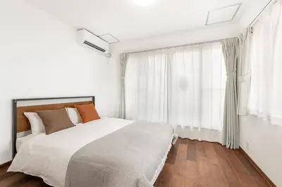 a bedroom with a bed and a large window at -Numabukuro House- 10-minute walk from Numabukuro station in Tokyo