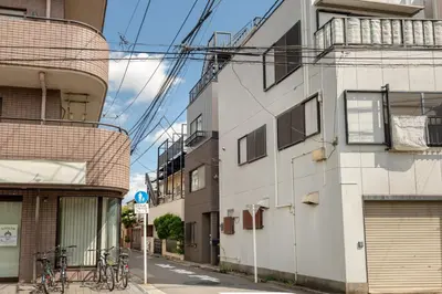 a street with two buildings with bikes parked on the sidewalk at -Numabukuro House- 10-minute walk from Numabukuro station in Tokyo
