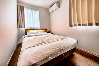 a bedroom with a large bed with a window at GH8197 Newly Designed Home with All Modern Conveniences in Tokyo