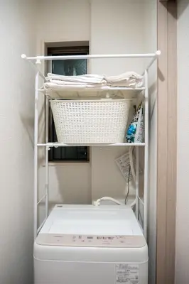 a laundry room with a toilet and a shelf above it at GH8197 Newly Designed Home with All Modern Conveniences in Tokyo