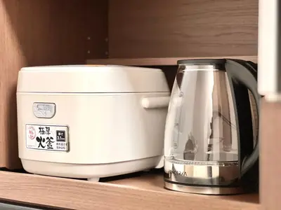 a white toaster sitting on top of a shelf at ManOku in Tokyo