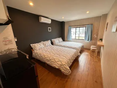 a small bedroom with a bed and a window at VanillaHotel-Fukagawa in Tokyo
