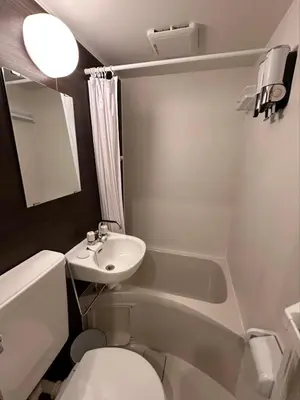 a small bathroom with a sink and a toilet at VanillaHotel-Fukagawa in Tokyo