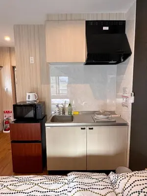a small kitchen with a sink and a microwave at VanillaHotel-Fukagawa in Tokyo
