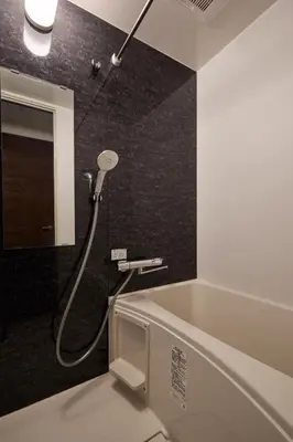 a bathroom with a shower and a bath tub at LIFE TOWN Yotsugi in Tokyo