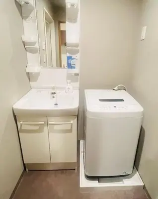 a small bathroom with a sink and a washing machine at incense\u4e0a\u91ce\u6839\u5cb82\uff26 in Tokyo