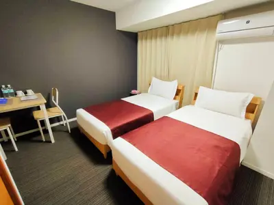 a hotel room with two beds and a table and a desk at incense\u4e0a\u91ce\u6839\u5cb86\uff26 in Tokyo