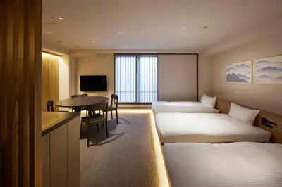 a hotel room with two beds and a table at Minn Asakusa Kuramae North in Tokyo