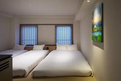 two beds in a room with two windows at Minn Asakusa Kuramae North in Tokyo