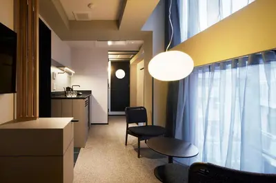 a room with a kitchen and a table and chairs at Minn Asakusa Kuramae North in Tokyo