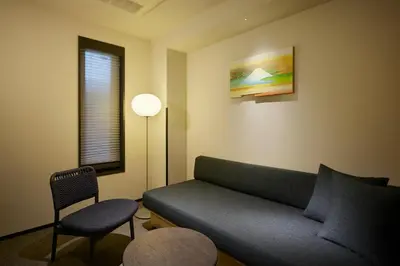 a living room with a couch and a chair at Minn Asakusa Kuramae North in Tokyo