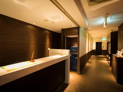 a hotel lobby with a reception desk and a hallway at SUPER HOTEL Tokyo Akabane Station Higashiguchi Ichibangai in Tokyo