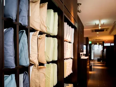 a closet filled with lots of different colored shirts at SUPER HOTEL Tokyo Akabane Station Higashiguchi Ichibangai in Tokyo