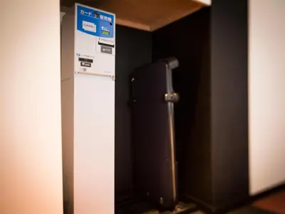 a refrigerator in a room with a sign on it at SUPER HOTEL Tokyo Akabane Station Higashiguchi Ichibangai in Tokyo