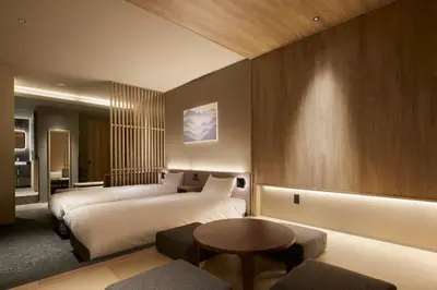 a hotel room with two beds and a table at Minn Asakusa Kuramae Station in Tokyo
