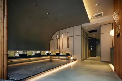 a lobby with a waiting room with couches and lights at Minn Asakusa Kuramae Station in Tokyo