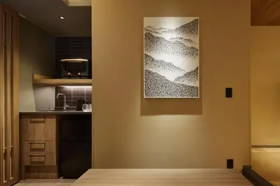 a kitchen with a painting on the wall at Minn Asakusa Kuramae Station in Tokyo