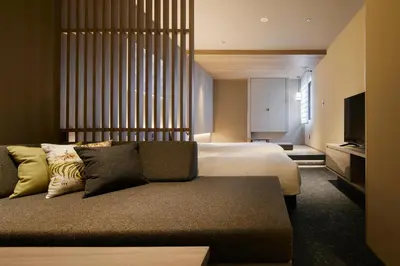 a hotel room with a bed and a couch at Minn Asakusa Kuramae Station in Tokyo