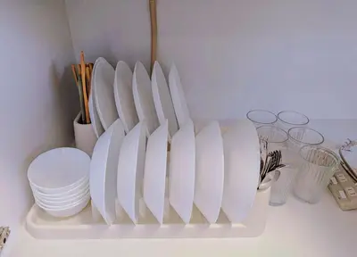 a shelf with white plates and bowls and glasses at incense\u4e0a\u91ce\u6839\u5cb89\uff26 in Tokyo