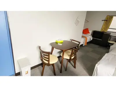 a room with a table and two chairs and a bed at Mamada Building - Vacation STAY 18001 in Tokyo