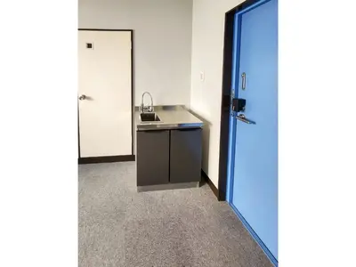 a small kitchen with a sink and a blue door at Mamada Building - Vacation STAY 18001 in Tokyo