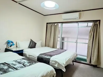 a room with two beds and a window at Mamada Building - Vacation STAY 18001 in Tokyo