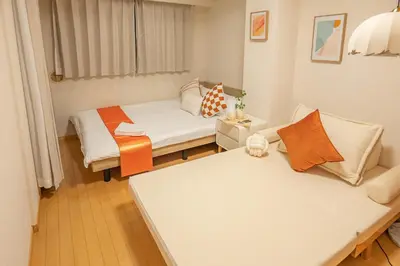 a small room with two beds and a couch at Higashi-Nakano 103 train 2 stops to Shinjuku ,up to 3 people in Tokyo