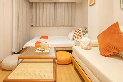 a small room with two beds and a table at Higashi-Nakano 103 train 2 stops to Shinjuku ,up to 3 people in Tokyo