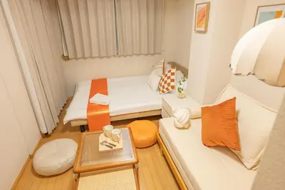 a small room with two beds and a table at Higashi-Nakano 203 train 2 stops to Shinjuku ,up to 3 people in Tokyo