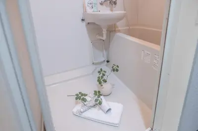 a small bathroom with a sink and a potted plant at Higashi-Nakano 203 train 2 stops to Shinjuku ,up to 3 people in Tokyo