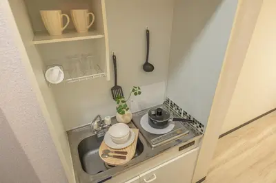 a small kitchen with a sink and a stove at Higashi-Nakano 203 train 2 stops to Shinjuku ,up to 3 people in Tokyo