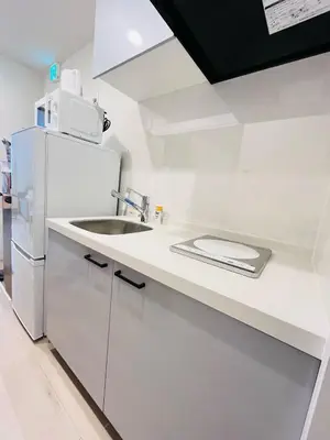 a white kitchen with a sink and a refrigerator at Year-end promotion 2 Gread location 1min to Station Closs Ueno Max 6 people Wi-fi unlimited in Tokyo