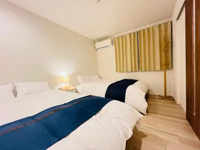 a bedroom with two beds and a window at Year-end promotion 2 Gread location 1min to Station Closs Ueno Max 6 people Wi-fi unlimited in Tokyo