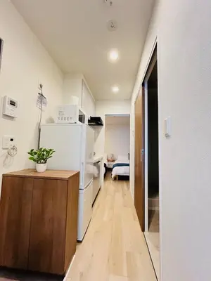 a kitchen with a refrigerator and a table in a room at Year-end promotion 2 Gread location 1min to Station Closs Ueno Max 6 people Wi-fi unlimited in Tokyo