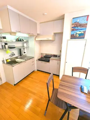 a kitchen with a table and a dining room at Asakusa Tokyo T'sRoom in Tokyo