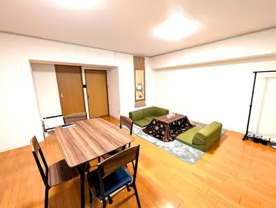 a living room with a table and a couch at Asakusa Tokyo T'sRoom in Tokyo