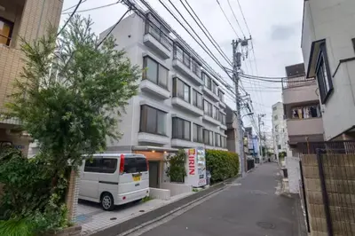 a white van parked in front of a building at PLAZA SINJUKU Cozy Mansion #2 in Tokyo