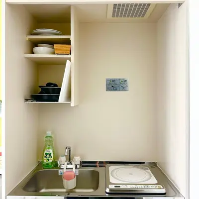 a kitchen with a sink and a counter top at PLAZA SINJUKU Cozy Mansion #2 in Tokyo