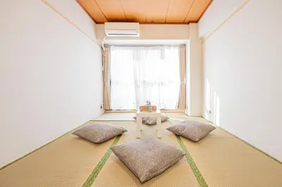 a room with three pillows on the floor with a window at \u65b0\u5bbf\u6b4c\u821e\u4f0e\u753a\u5f92\u6b65\u4e09\u5206\u9418\u4e09\u623f\u4e00\u5ef3\u8fd1\u9130\u4f0a\u52e2\u4e39 in Tokyo