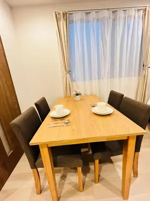 a wooden dining room table with chairs and a window at Year-end promotion Free Wi-Fi spacious and bright Closs Ueno 1min to Minowa Sta Wide Room Max 4People in Tokyo