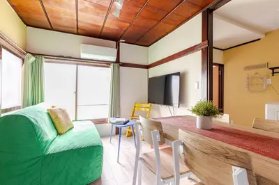 a room with a dining table and a television at NakakasaiKodateNKK1 in Tokyo