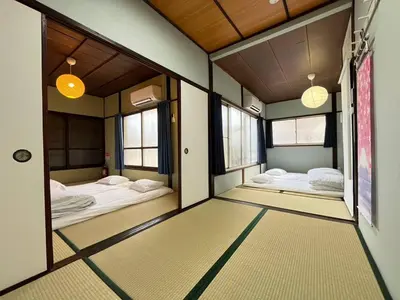 a room with three beds in it with windows at NakakasaiKodateNKK1 in Tokyo