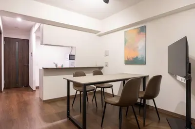 a dining room with a table and chairs at The Parkcross\u4e21\u56fd\u7dd1 in Tokyo