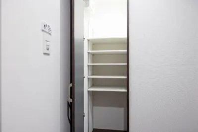 an open door to a closet with shelves at The Parkcross\u4e21\u56fd\u7dd1 in Tokyo