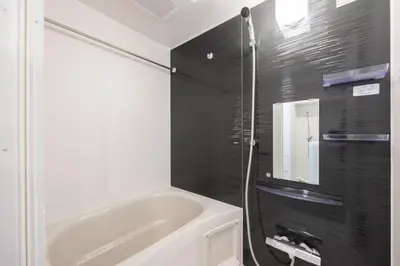 a bathroom with a white tub and a black wall at The Parkcross\u4e21\u56fd\u7dd1 in Tokyo
