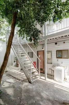 a white staircase leading up to a building at \u30a2\u30f3\u30c9\u30b9\u30c6\u30a4\u4e2d\u91ce5\u4e01\u76ee102 in Tokyo